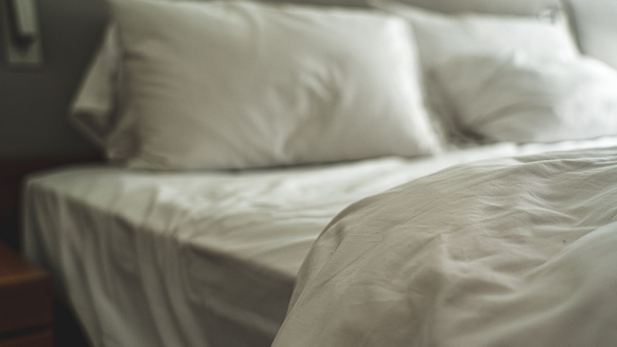 White bed with soft pillows and natural morning light