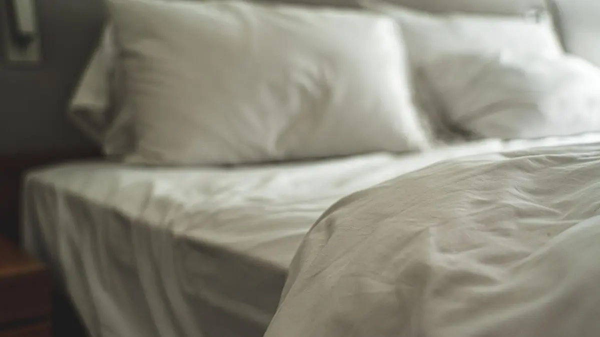 White bed with soft pillows and natural morning light