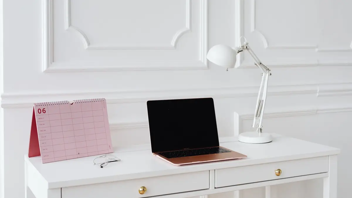 Desk calendar and laptop on a white desk
